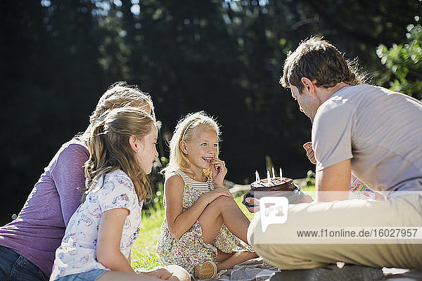Family celebrating birthday outdoors
