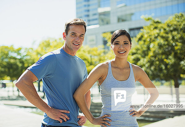 Smiling joggers in urban park