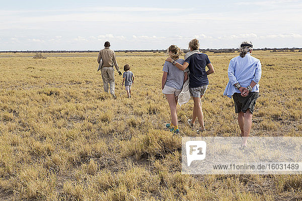 family looking at Meerkats (mongoose)  Kalahari Desert  Makgadikgadi Salt Pans  Botswana