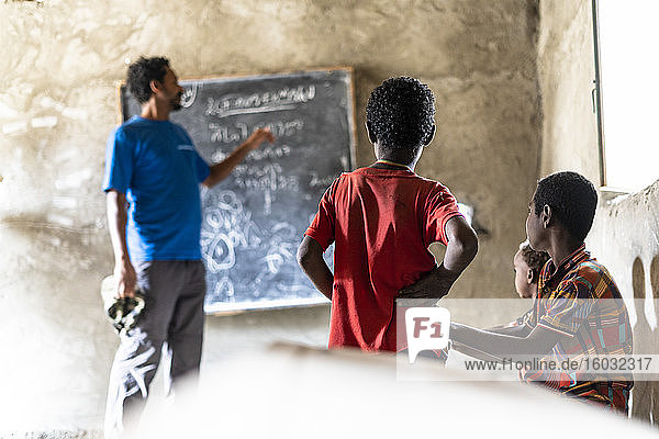 Teacher and kids in school classroom  Melabday  Asso Bhole  Danakil Depression  Afar Region  Ethiopia  Africa