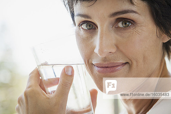 Close up portrait woman drinking water