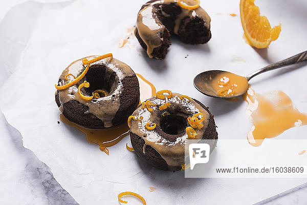 Vegane ofengebackene Schokoladen-Donuts mit Orangenglasur und Orangenzesten