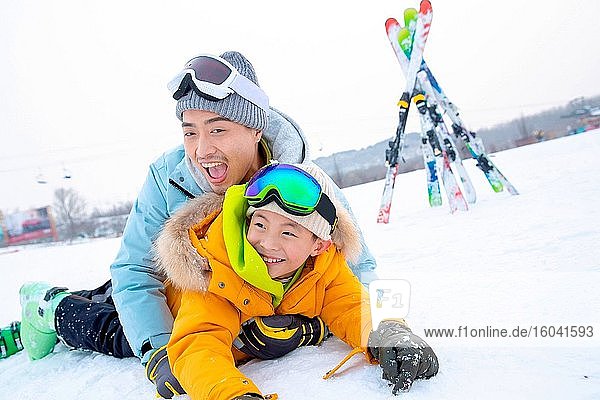 Skiing field in rolling happy father and son together