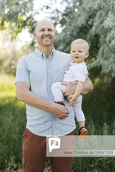 Outdoor portrait of father with baby son
