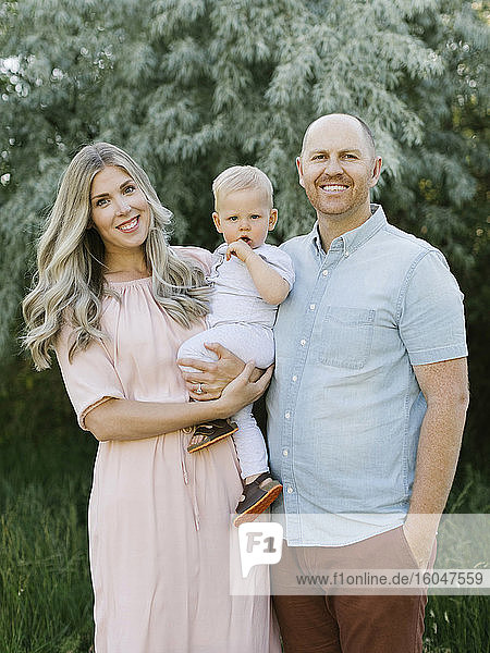 Portrait of smiling parents with baby boy