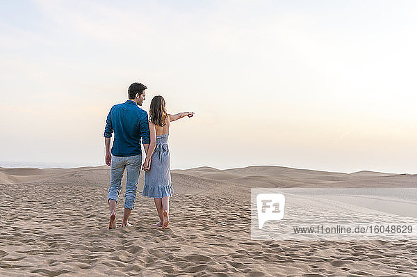 Couple at sunset in the dunes  Gran Canaria  Spain