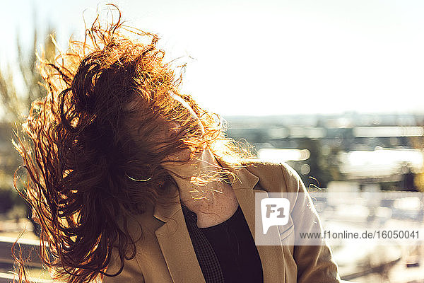Frau mit roten Haaren an einem sonnigen Tag