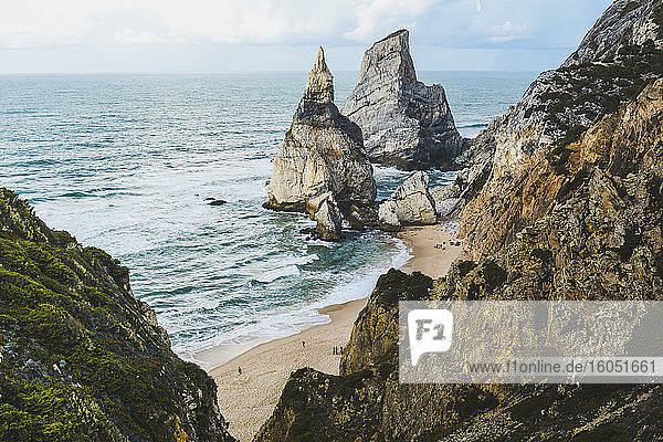 Scenic view of seascape and rock formations against sky at Ursa beach  Portugal