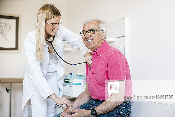Ärztin bei der Untersuchung eines älteren Patienten in einer medizinischen Klinik