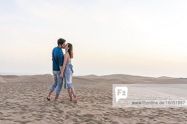 Couple kissing at sunset in the dunes  Gran Canaria  Spain