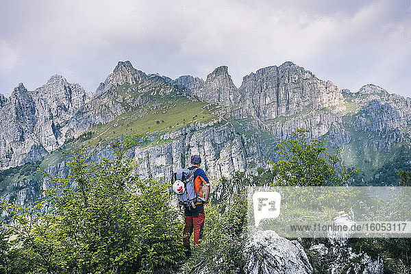 Hiker standing on mountain path enjoying view  Orobie  European Alps  Como  Italy