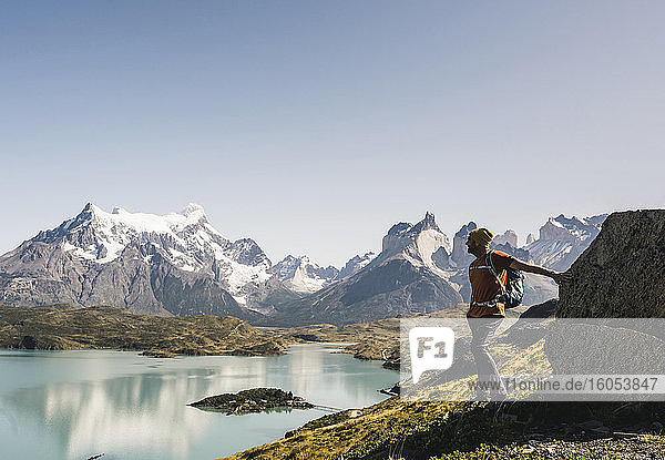 Man standing by lake against clear sky  Torres Del Paine National Park  Patagonia  Chile