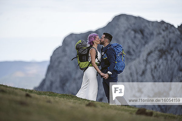 Kissing bridal couple with climbing backpacks at Urkiola mountain  Spain