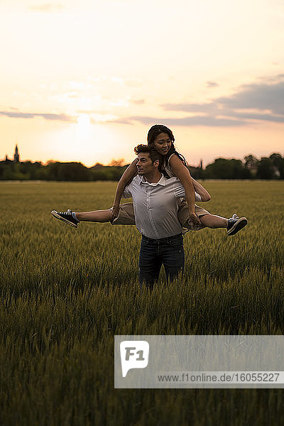 Dancing couple on field during sunset