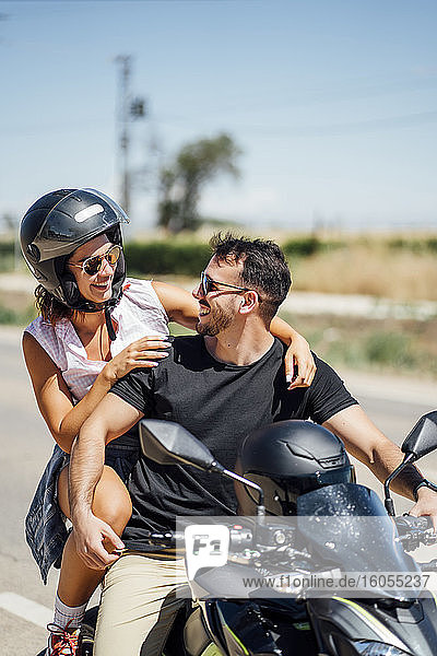 Couple sitting on motorbike