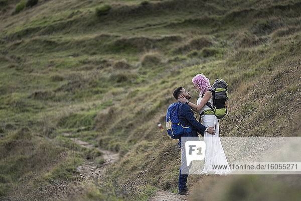 Bridal couple with climbing backpacks at hiking trail  Urkiola mountain  Spain