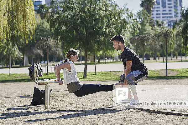 Woman during work out with coach in park