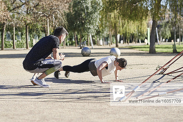 Woman during work out with coach in park