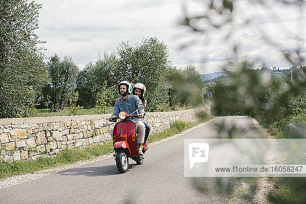 Couple enjoying road trip on Vespa  Tuscany  Italy
