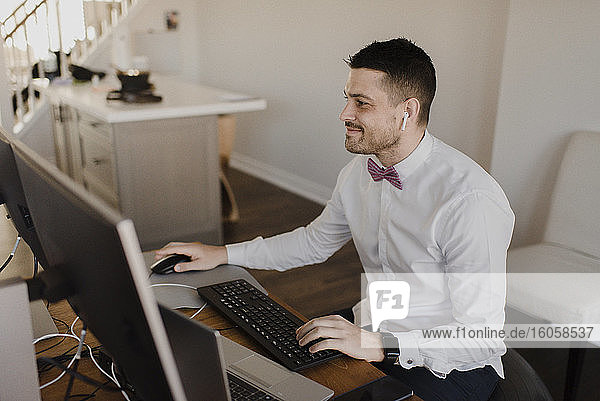 Businessman using computer on desk at home