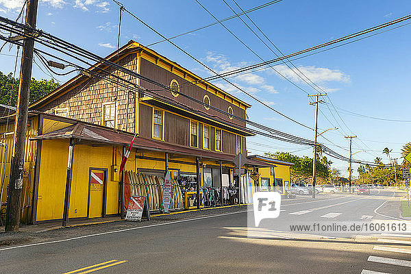 Surf town of Haleiwa  with a bright yellow building renting surfboards; Haleiwa  Oahu  Hawaii  United States of America