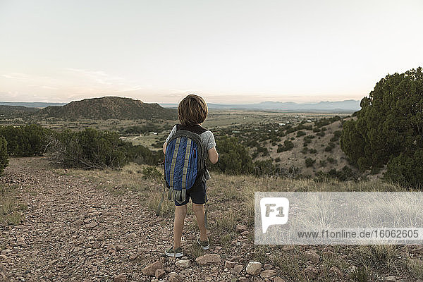 4 year old boy hiking at sunset Lamy NM