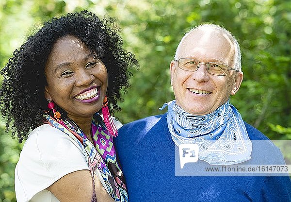 Portrait of a laughing married couple  dark-skinned woman and light-skinned man  mature couple  Germany  Europe