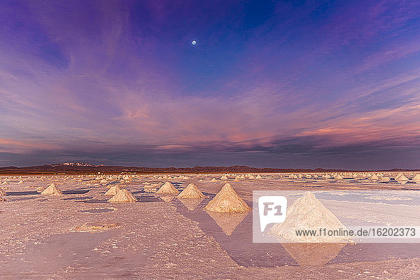 Salt stacks collected on salt flats at sunset, Salar de Uyuni, Southern Antiplano, Bolivia, South America