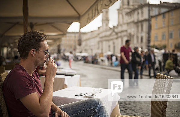 Man enjoying espresso at restaurant  Piazza Navona  Rome  Italy