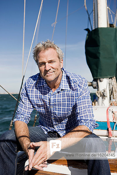 Portrait of man on yacht wearing checked shirt