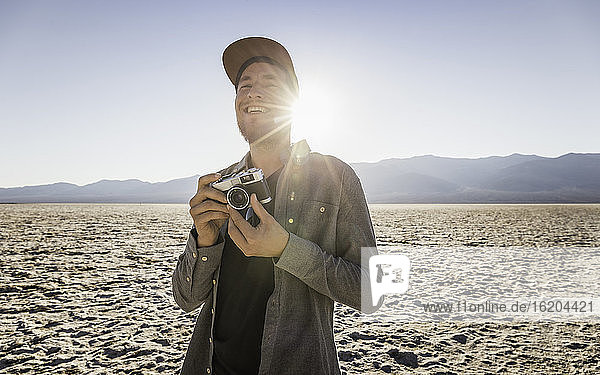 Man with camera  Badwater Basin  Death Valley National Park  Furnace Creek  California  USA