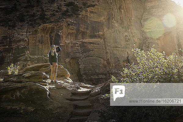 Woman standing on rocks  looking at view  Zion National Park  Utah  USA