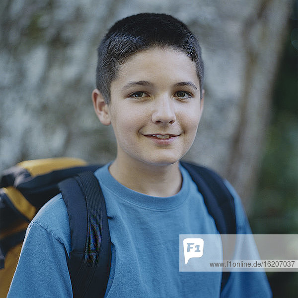 Portrait of happy adolescent boy wearing backpack