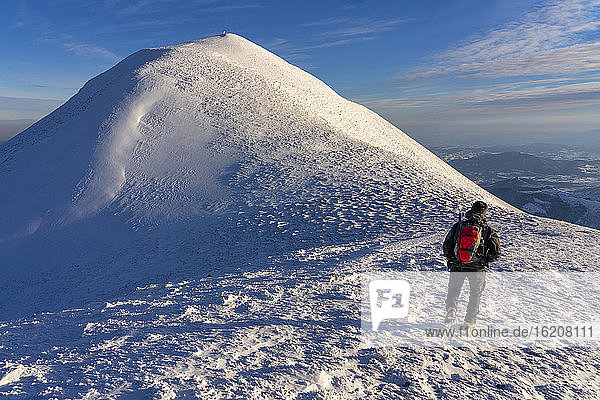Hiker near the summit in winter  Mount Acuto  Apennines  Umbria  Italy  Europe