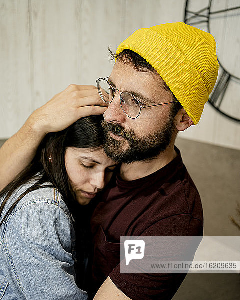 Affectionate couple embracing at home