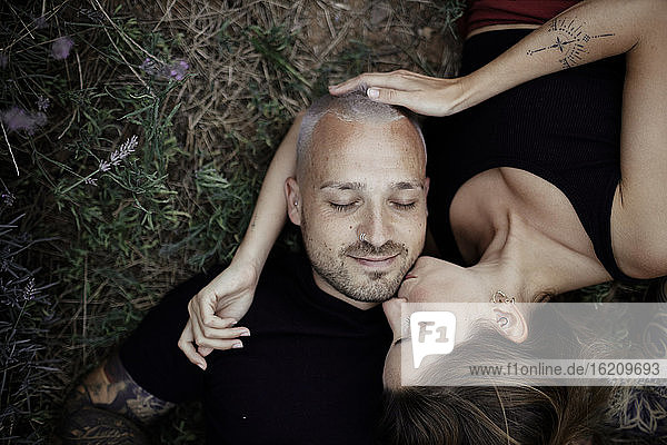 Happy couple lying on lavender field