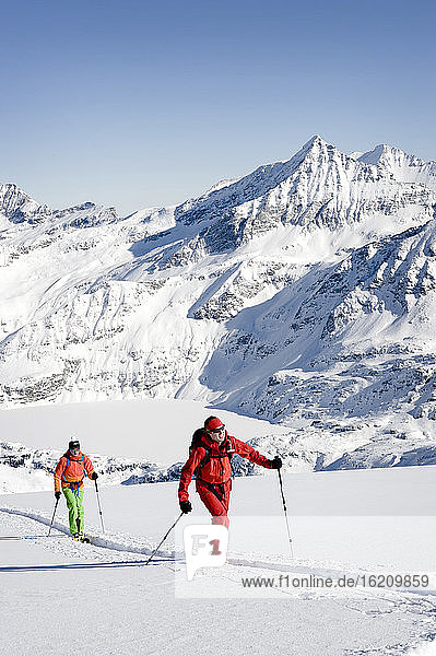 Austria  Men skiing on mountain at Salzburg Land