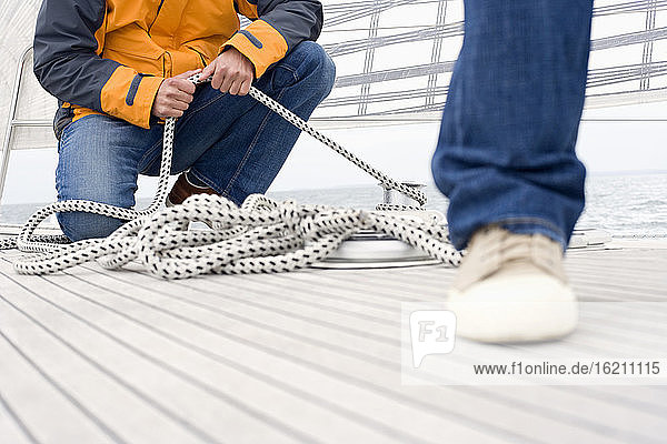 Germany  Baltic Sea  Lübecker Bucht  Man holding rope