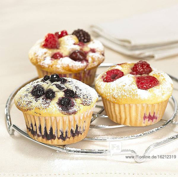 Raspberry and blueberry muffins on grill  close-up
