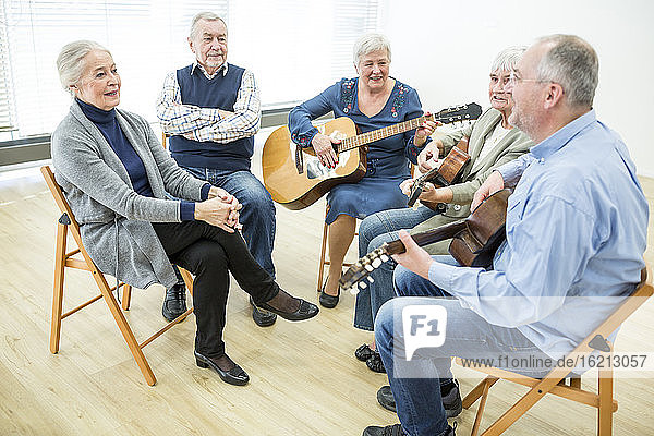 Senioren im Altersheim besuchen Gitarrenkurs  machen Musik