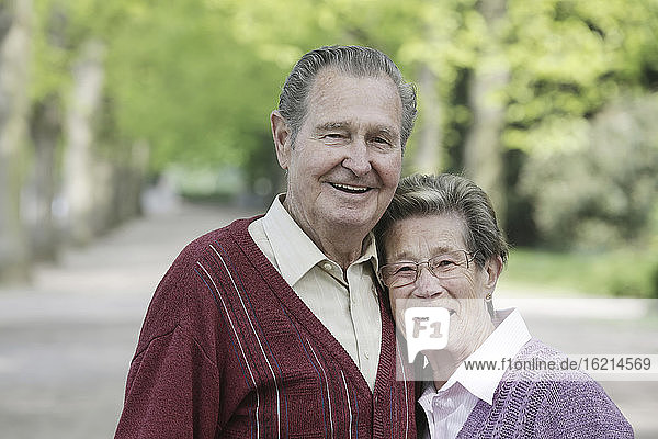 Germany  Cologne  Portrait of senior couple in park  smiling
