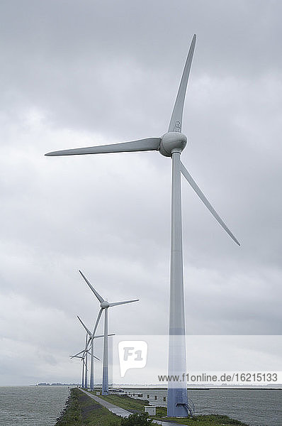 Netherlands  Ijsselmeer  View of wind turbine on causeway
