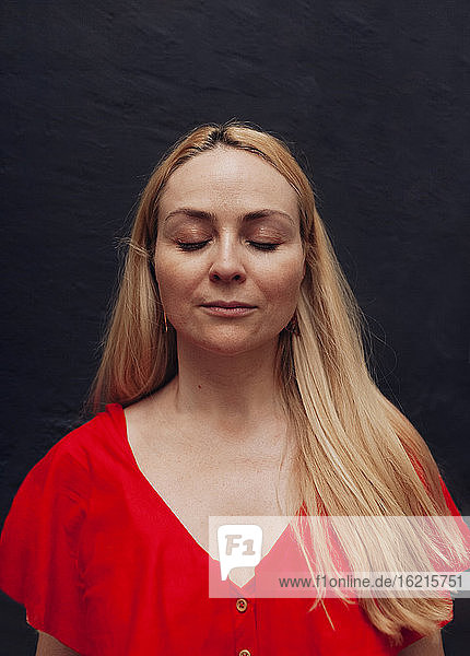 Porträt einer blonden Frau mit geschlossenen Augen