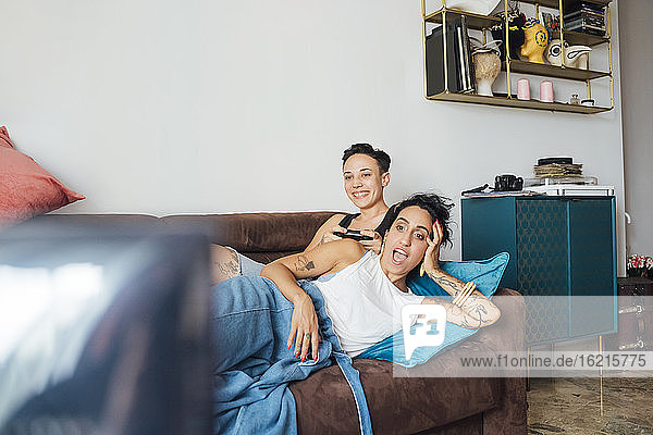 Lesbisches Paar sieht auf dem Sofa fern