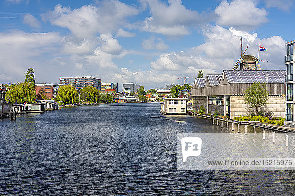 Netherlands  South Holland  Leiden  Clouds over Rhine city canal and adjacent buildings