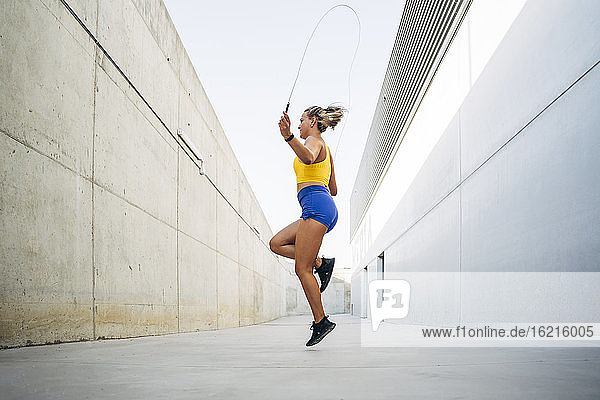 Young woman skipping rope