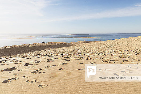 Scenic view of Pilat dunes and Atlantic ocean against sky during sunny day  Dune of Pilat  Nouvelle-Aquitaine  France