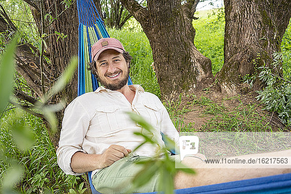 Man relaxing on hammock in the forest