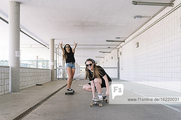 Young woman skateboarding in underpass
