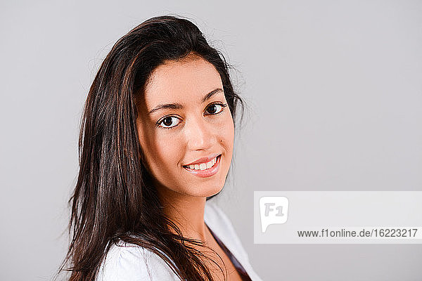 isolated studio shot of a beautiful and cheerful young brunette woman